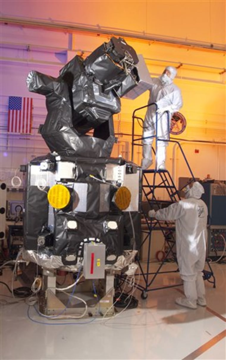 Technicians work on the Space-Based Space Surveillance satellite in Boulder, Colo. The satellite is a $500 million U.S. Air Force spacecraft that will provide the first full-time, space-based eye on thousands of other satellites and pieces of debris that could crash into American assets circling the Earth.